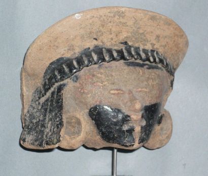 Pink terracotta fragmentary head with bitumen...