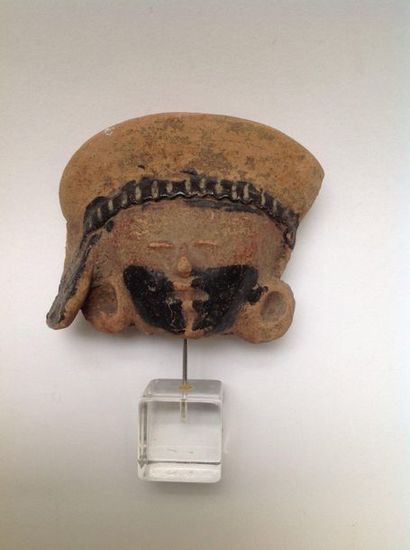 Pink terracotta fragmentary head with bitumen...