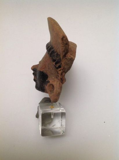 Pink terracotta fragmentary head with bitumen...