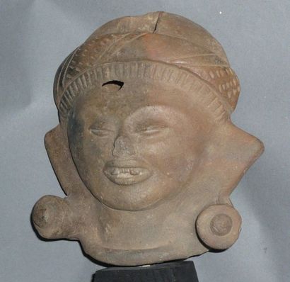 Large smiling head in beige terracotta. His...
