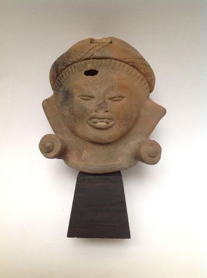 Large smiling head in beige terracotta. His...