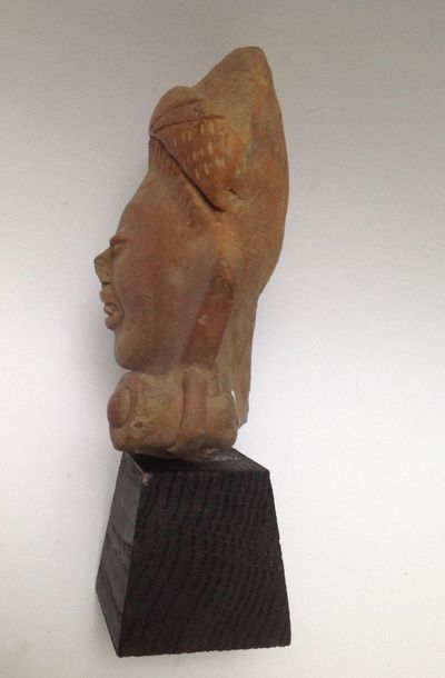 Large smiling head in beige terracotta. His...