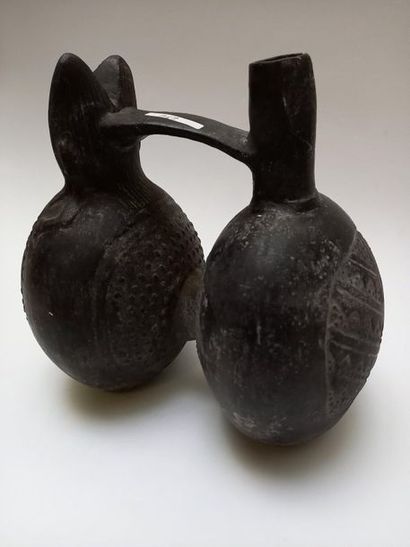 Double-bellied black ceramic stirrup vase....