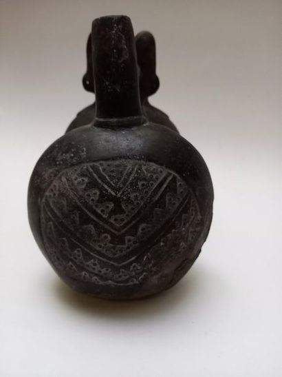 Double-bellied black ceramic stirrup vase....