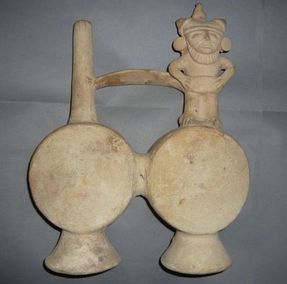 Flat double-bellied vase joined by a handle....