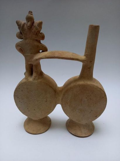 Flat double-bellied vase joined by a handle....