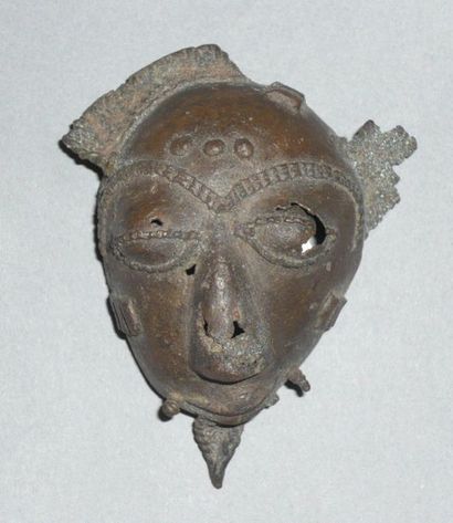 Old brass talisman mask with a patina of...