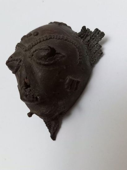 Old brass talisman mask with a patina of...