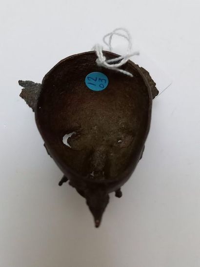 Old brass talisman mask with a patina of...
