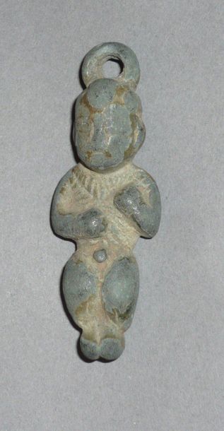 Bronze pendant amulet with green patina representing...
