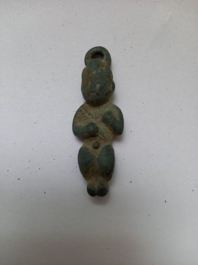 Bronze pendant amulet with green patina representing...