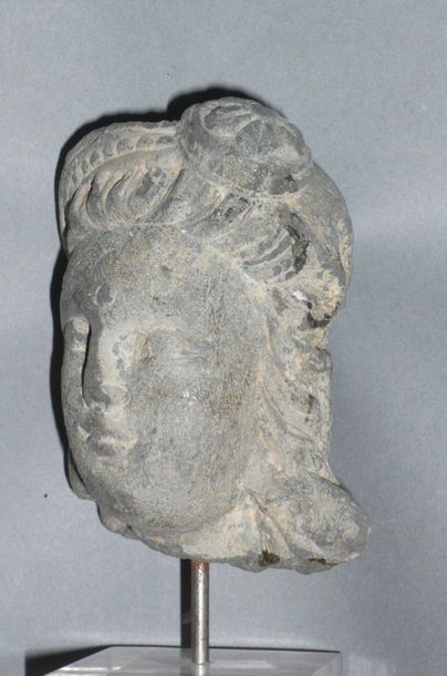 Head of a woman with a bun in grey shale....
