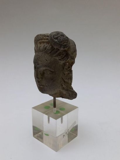 Head of a woman with a bun in grey shale....