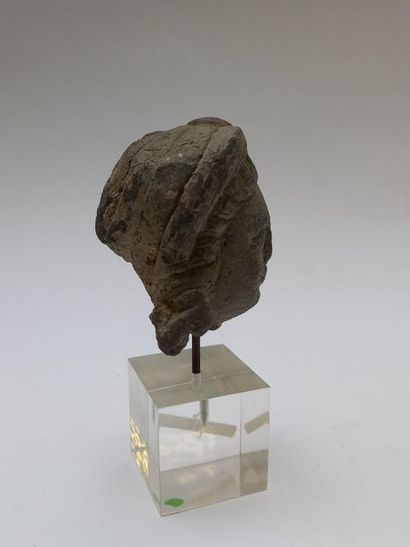 Head of a woman with a bun in grey shale....