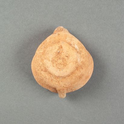 A Punic oil lamp in pink clay with a collar...