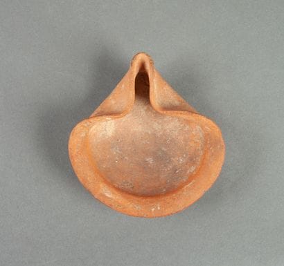 Red earthenware oil lamp with pinched spout.

Phoenicia...