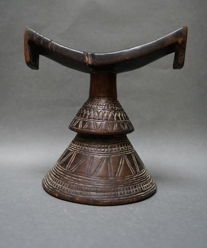 Red wood neckrest decorated with incised...