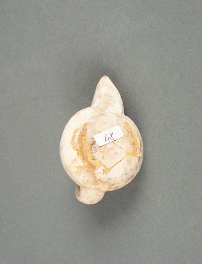 A glazed terracotta oil lamp with a pointed...