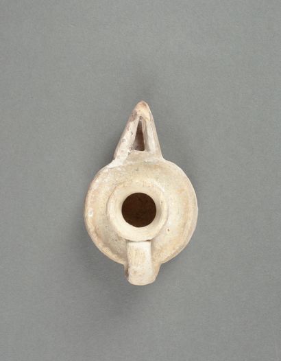 A glazed terracotta oil lamp with a pointed...
