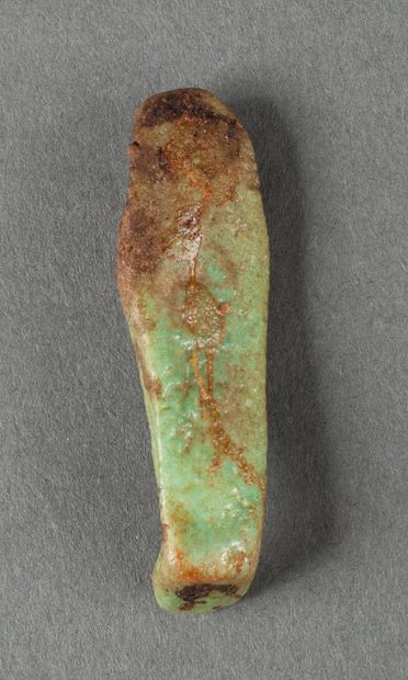 Oushebti miniature en fritte émaillée verte.

Egypte,...