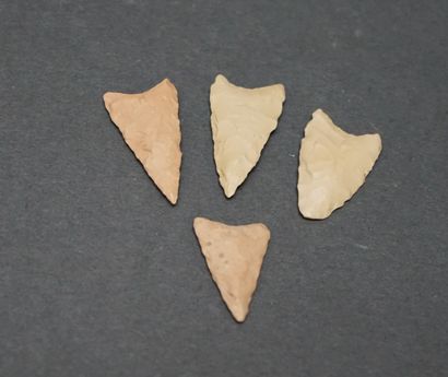 Four white flint arrowheads with wings. Neolithic....