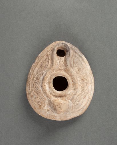 Beige terracotta oil lamp with latticework...