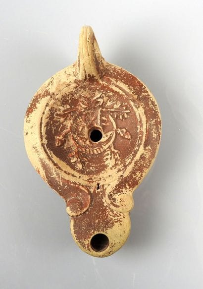 Oil lamp with ogival spout and simple scrolls...