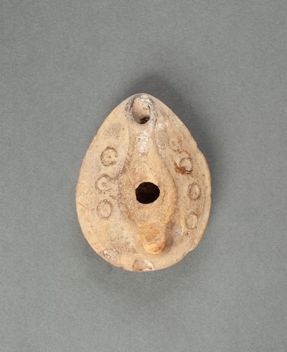 Beige terracotta oil lamp with circles decoration...