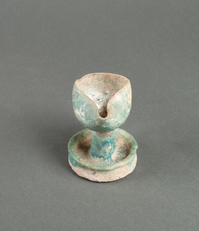 Oil lamp on a green glazed ceramic pedestal...