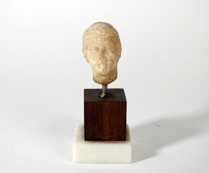 Head of a young woman with curly hair held...