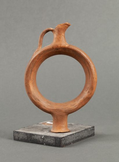 Rare orange terracotta ringed flask on a...