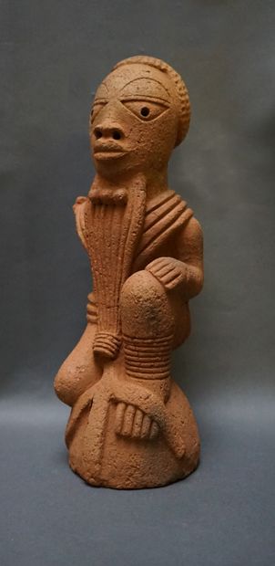 Anthropomorphic sculpture of a kneeling man...