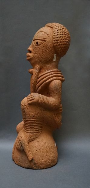 Anthropomorphic sculpture of a kneeling man...