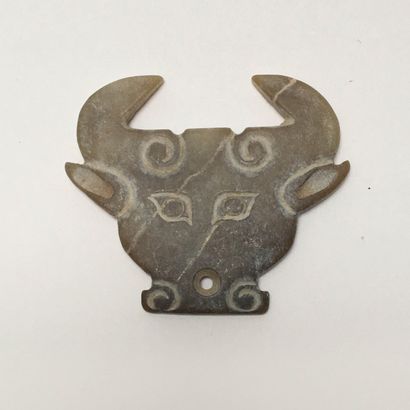 Very stylized brown/yellow jade bovine head....