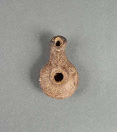 Oil lamp in brown terracotta with traces...