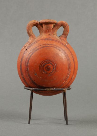 Orange terracotta flask decorated with brown...