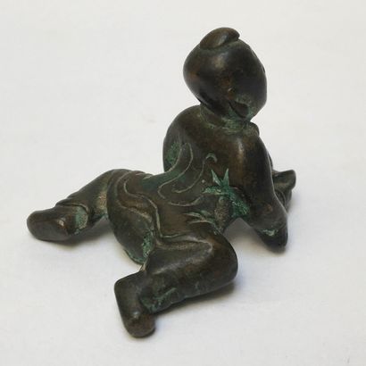 Oxidized bronze scribe's weight. It represents...