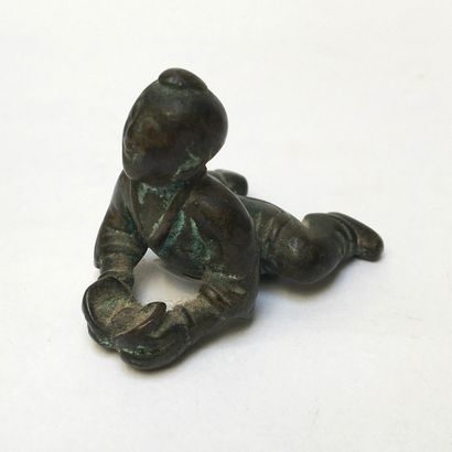 Oxidized bronze scribe's weight. It represents...