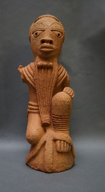 Anthropomorphic sculpture of a kneeling man...