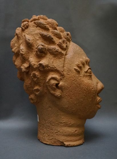 Head made of low-baked clay, with scarified...