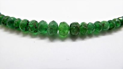 NECKLACE of faceted emerald beads in fall,...