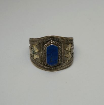 A large rigid silver BRACELET centered on...