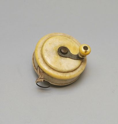 Sliding tape measure with ivory frame. Circa...