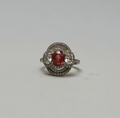 A white gold ring set with an oval Padparadscha...