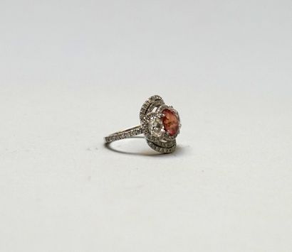A white gold ring set with an oval Padparadscha...