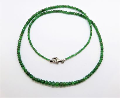 NECKLACE of faceted emerald beads in fall,...