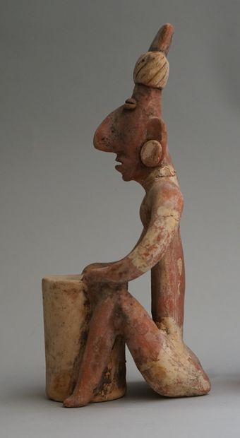 Anthropomorphic sculpture of a seated figure...