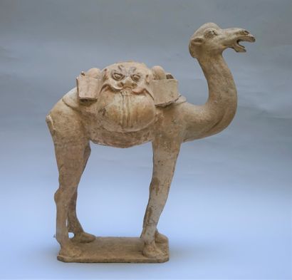 A beige terracotta camel with white polychrome...