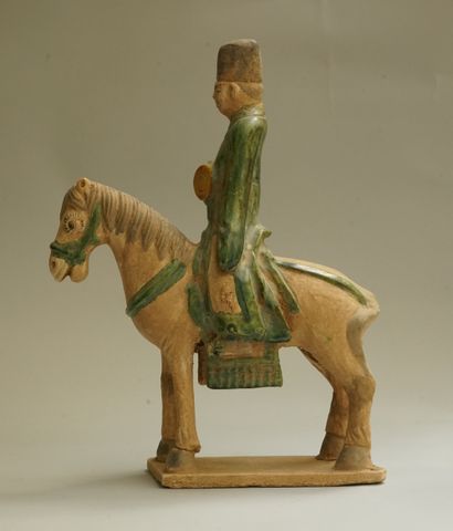 A beige earthenware musician on horseback...