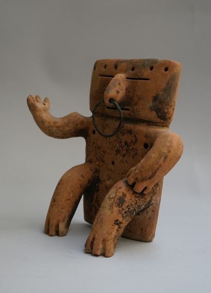 Anthropomorphic statuette showing a seated...